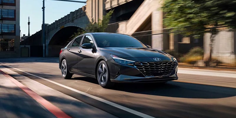 hyundai sedan driving on a city road