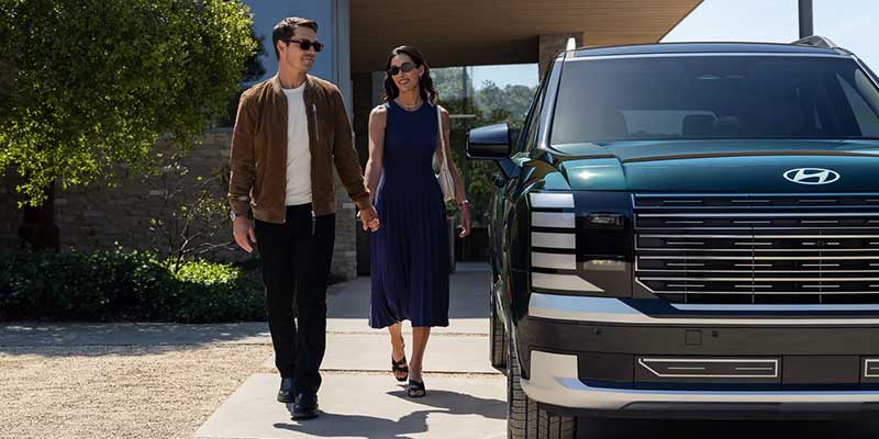 beside 2026 Hyundai Palisade the couple is standing happily