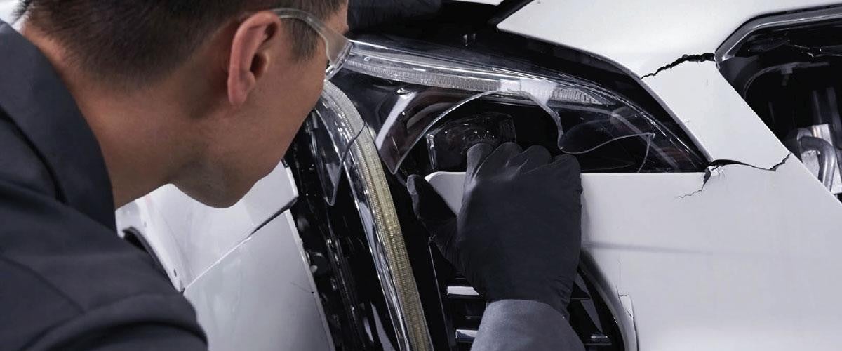 Technician polishing a car headlight